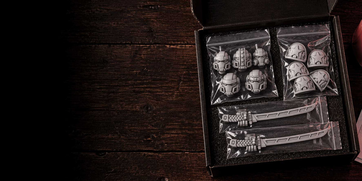 Box of grey resin sci-fi conversion parts packed for shipping